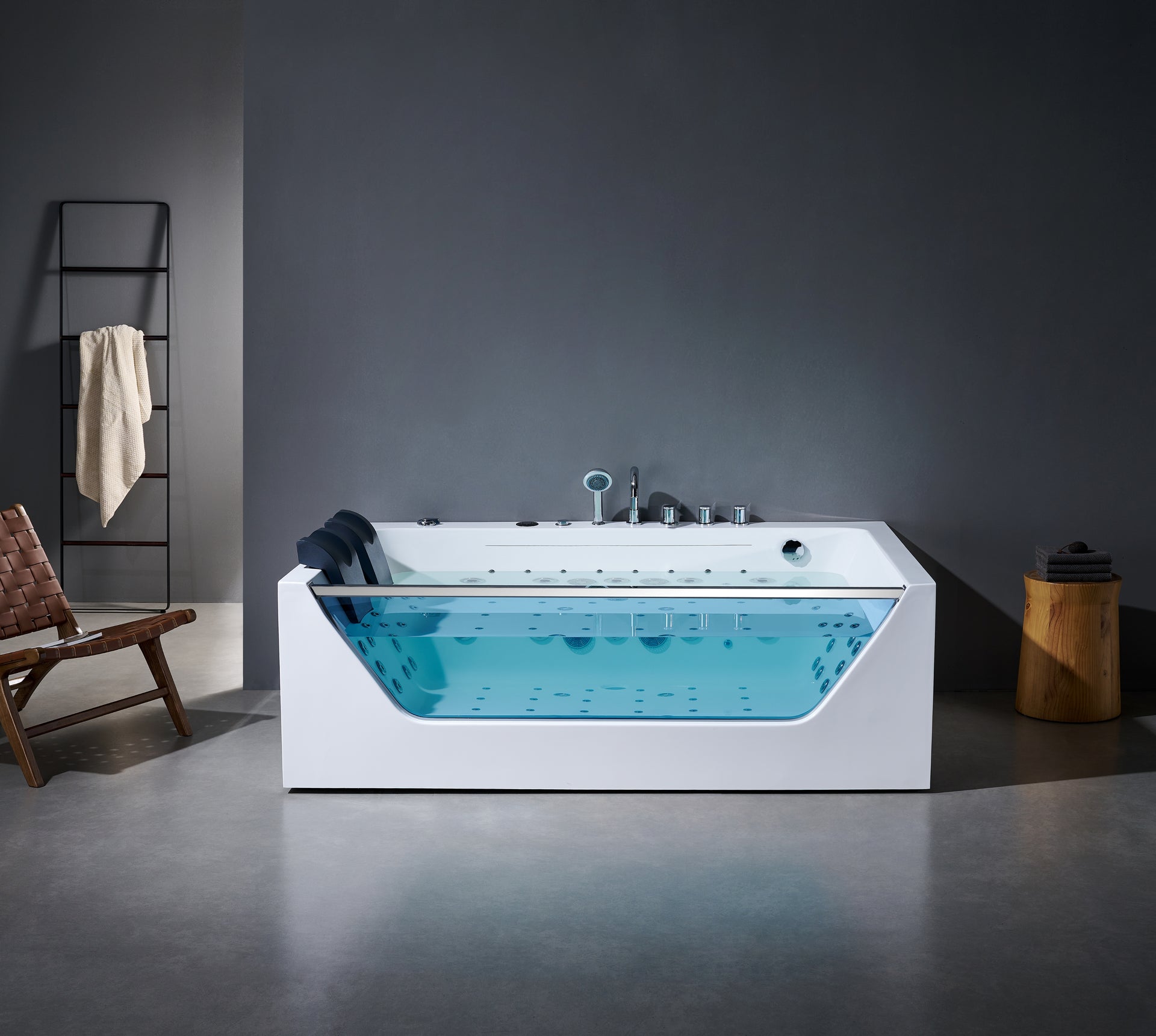 Modern bathtub with blue water in a minimalistic bathroom setting