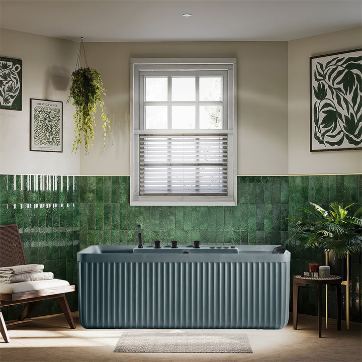 Modern bathroom with green tiled walls, a bathtub, and decorative elements.